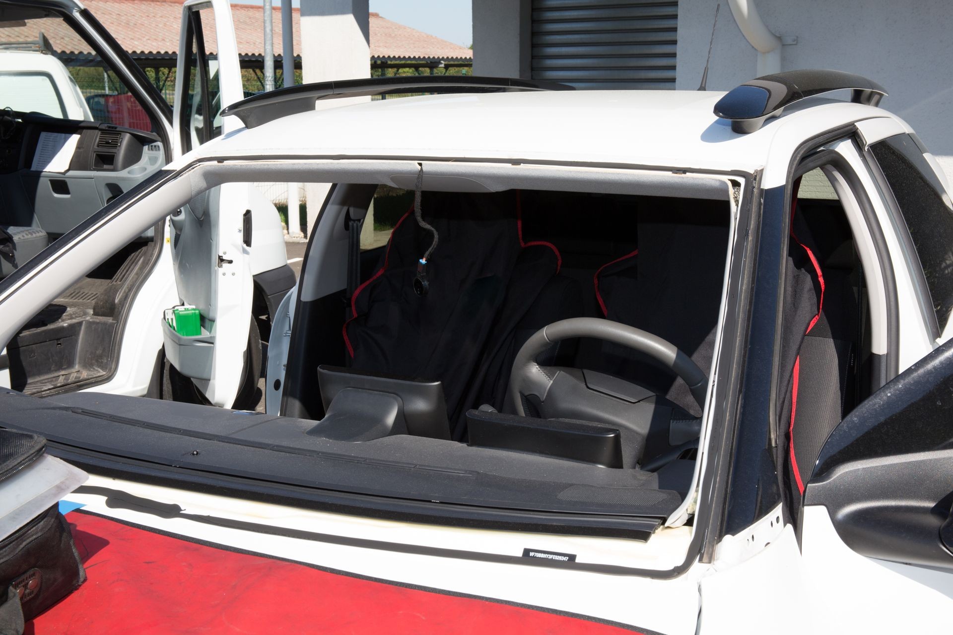 Glazier removing windshield or windscreen on a car