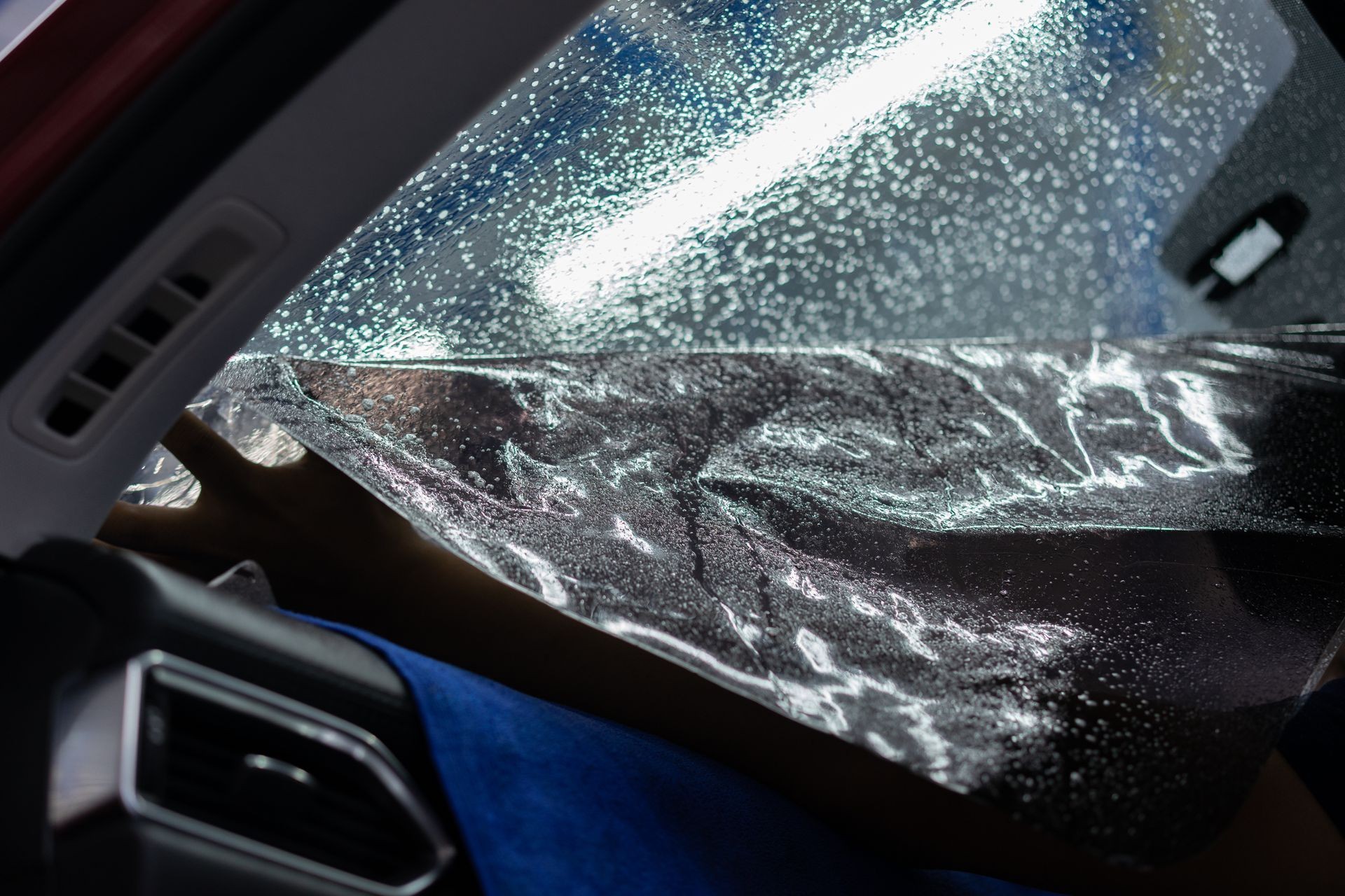 Car window tinting operation in specific room. Car window tinting operation in specific room.